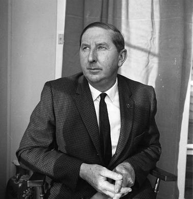 Portrait of a man dressed in a suit and tie.