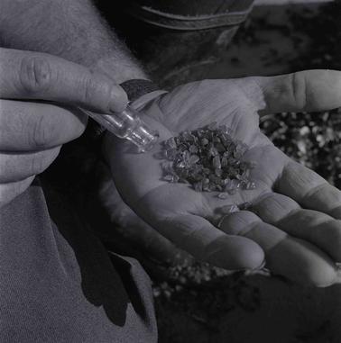  A man’s hand displaying saphires found at Point Leo.