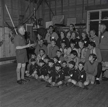 A group of Scouts and Cubs with four adults.  One adult is in Scout uniform.
