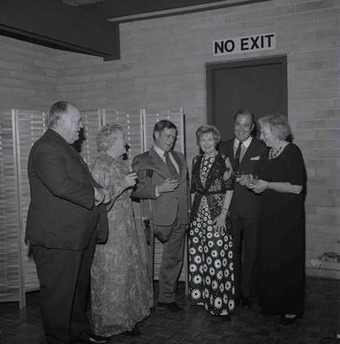 Five people in formal attire posing for the photograph.