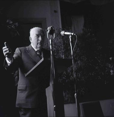 A man speaking into two microphones.