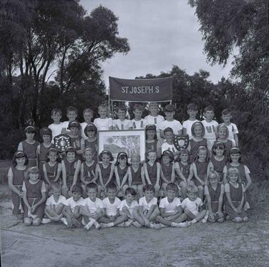 A group photograph of children  in sports uniforms.