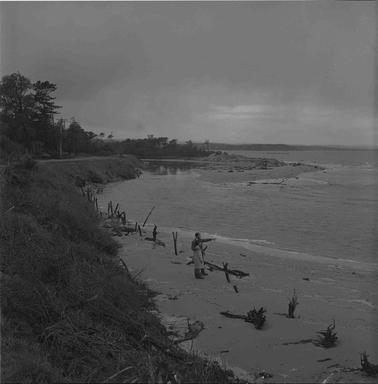 A man and girl at the estuary of a creek.  The man has his arm around the girl’s shoulders and is pointing into the distance across the Bay.