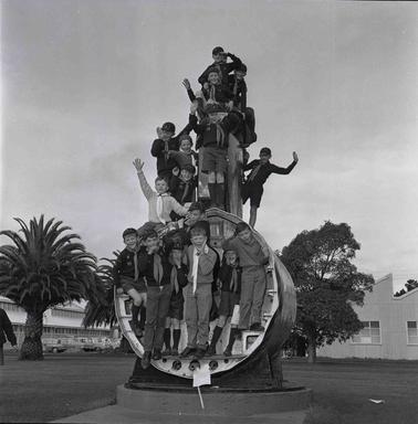 Children posing at a part of a submarine.