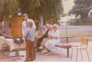 Chariman, School Council, Greg Gibbs, presenting Kenneth Mackay with Rotary Award.  Principal Bill Williamson in background.  Seated from left: Ms Emma & Mr Wilfred Rowley (Chairman of School Committee for 21 years); Mrs Tess and Mr Jim Healey of Rye Newsagency (who donated Sports Awards).  17 Lyons Street in Background (formerly “Alma House” a summer boarding house).