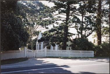 The gatehouse has a two storey central section over the arched gateway with side wings an oriel, stair, turret, depressed arches, square pinnacle and Gothic patterns decorate the structure