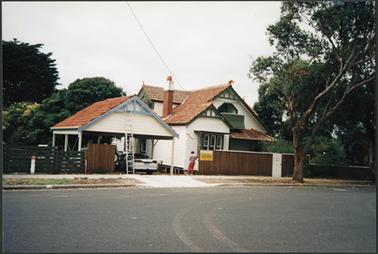 Double fronted 2 story with attic Federation weather board with tiles chimney verandah gargoyles on roof newly built double carport with pitched tiled roof