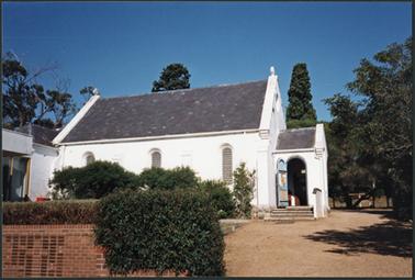 View of the St. James Church from Kunyung Road showing modern additions at rear left side 
the brick, simply gabled church rests on local granite footings and has a slate roof and porch