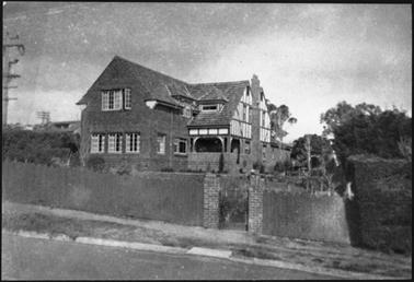 The house appears to be of two stages, a double-gabled and verandahed wing with half-timbered or
strapped walls at the back and projecting brick gabled at the front the upper and lower openings of the
front wing suggest a date from the late 1930’s or later