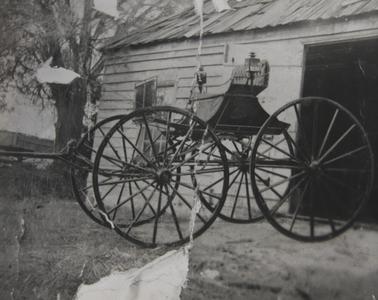 Coach outside timber workshop shed.