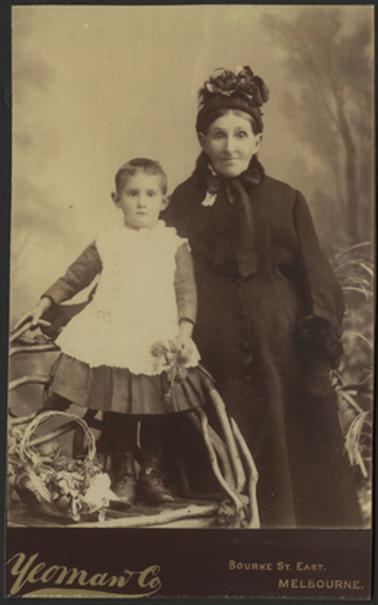 This image shows a large area under development.  There are mangroves and piles of soil in the foreground.  A shop with a red telephone box outside is in the background at the centre of the image.  Three large pine trees are on the left with picnic tables underneath.  