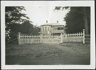 Front view from Barkly Street altered from 1921 image two storey house now stuccoed upper verandah with glass windowed false wall part enclosed balustrade blocked in picket fence with gate in the centre at the front of the house