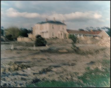 Two storey stucco house with extension wing for Aged Care facility, the photo was taken from the roundabout showing earthworks being undertaken in foreground
