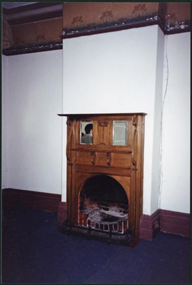 Front room of the home ‘Bellavista’, showing wooden surround of fireplace, with two mirrors inset, wallpaper dado high on walls auction day 13 Feb 1994