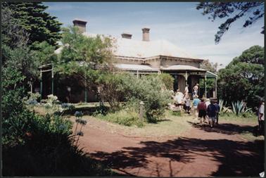 Front of the home ‘Bellavista’ showing driveway and garden, with people inspecting site before auction