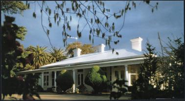 A calendar photograph of  ‘Ranelagh’ which has a brick gabled roof with detailed pillared verandah to two sides, french glassed doors and large windows landscaped garden, built 1938