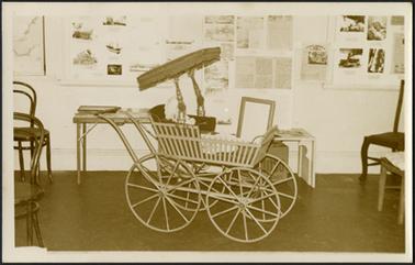 A view of the historical society museum display in 1970 showing an American heritage pram with the hood open doll sitting in the pram