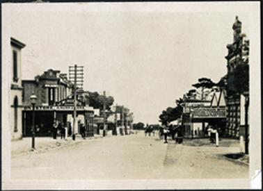 A view of Main Street, Mornington looking north showing telegraph poles on west side of street also gas street light Nunns Store on the left and Bank on the right