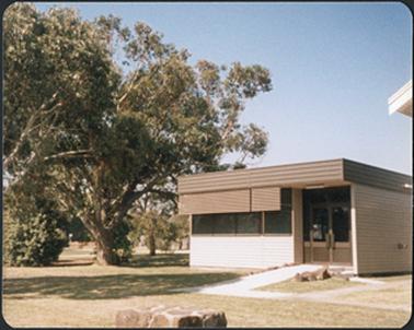 Prefab building set amongst trees behind the Court House