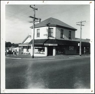 Two storey hipped roof with verandah and gabled roof dwelling on left four upper windows, with corner angled