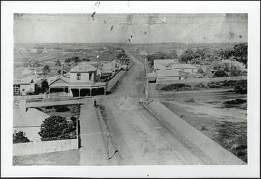 View of Main Street, Mornington looking south from the Grand Hotel, a view of a double storey brick building with verandah with the name J.D. Grover on the verandah roof can be seen from the Hotel