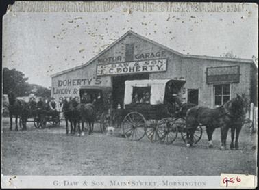 The tin shed is ‘Doherty's Livery and Stables’, also held ‘G. Daw and Sons Motor Garage’ in front of the shed
are three buggies and horses