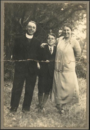 The image shows Rev and Mrs Youngson standing together, with perhaps their son, in an outdoor setting