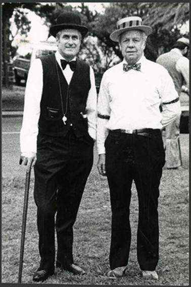 Two men, Neil Taylor and Clarrie Rawlings dressed in period costume standing side by side in the Mornington Park