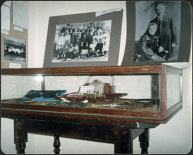 Display item in cabinet and photographic displays on walls at the OPOM Mornington