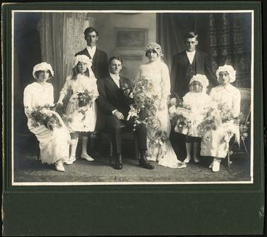 A group wedding photo of the wedding of Alfred Stone and Annette Baird c1891 standing in photo, Ted Stone and Roy Stone, seated far side Ivy Stone (Young)