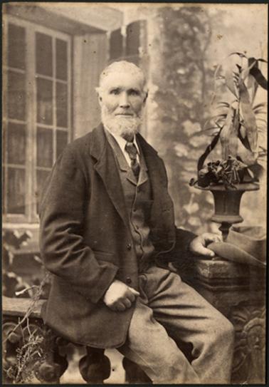 A portrait of James Firth, taken in a garden setting