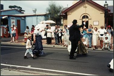 Win Corkhill and Neil Taylor dressed in period costume walking passed the Old Post Office Museum in the Australia Day procession