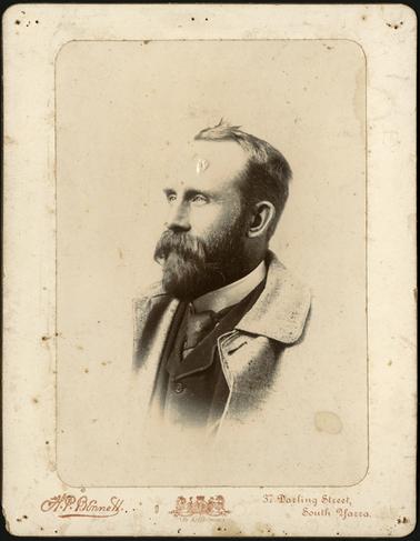 A head and shoulders image of Charles S. Bennett, turned to the left in photo, as though in thoughtful pose