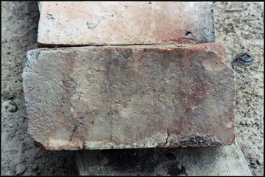 The image shows a handmade brick at the site of Osborne House thumbprint top right corner