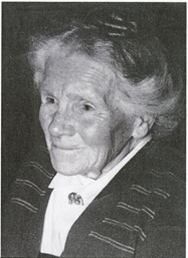 The photo shows a head and shoulders image of Emily Stone as she looks side on to the left