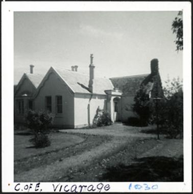 A front view of the Vicarage the house is stuccoed with L-shaped plan around the entrance door