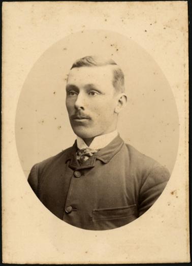 A portrait of a man, looking to the left, wearing buttoned up shirt and jacket, image in oval frame