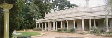 Beleura c1863 a large single storied stucco house the main body of the symmetrical house has a balustraded parapet above the main façade with a colonnade of corinthian columns supporting a separate verandah