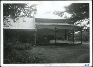 A side view of Woodclyffe c1860, a stuccoed Italianate villa with encircling bayed verandah