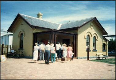 A view of the entrance of the Old Post Office Museum on Australia Day 1988, with several people waiting at the entrance