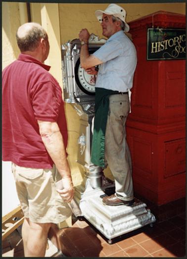 Neil Taylor standing on the new $1.00 machine installed for weight (scales), taken Australia Day 2002