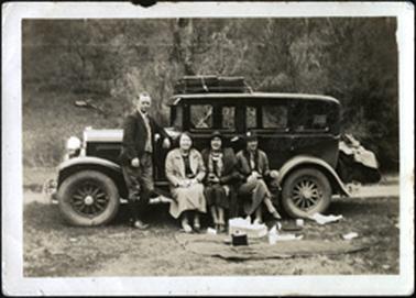 The image shows Bradford family members, three females and one male, having a meal break near their car on their trip to Buffalo 1933