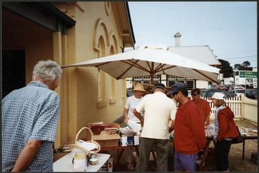 The image shows people looking through books at the Book Stall outside the OPOM on Australia Day 2003