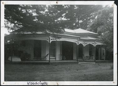 A front view of Woodclyffe c1870, a stuccoed Italianate villa with an encircling bayed verandah, the windows being double hung and the main entry appearing to have side panels