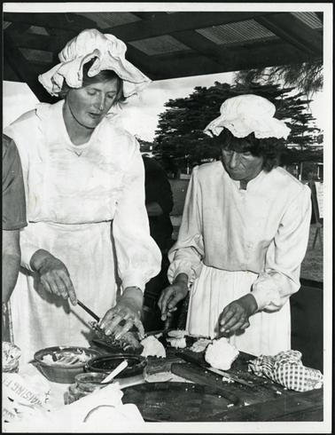 Mary Picking and Pat Handley preparing food at the Picnic in the Park