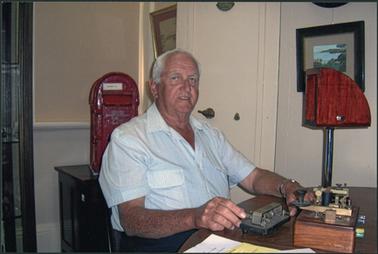 Bill Hall sitting at his morse code ‘jigger’ at the OPOM Mornington, Dec 2005