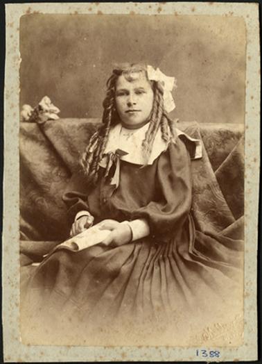 A portrait of Miss Wyn Bradford taken in a set pose by photographer