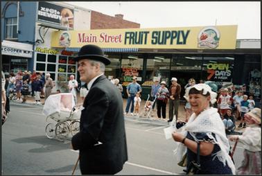 Australia Day Parade 1995 theme was “Transport” procession passing Main St. Fruit Supply showing Neil Taylor and Win Corkhill in period costume