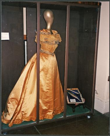 A satin gold ball gown on display for Heritage Week 1988 at the Mornington Historical Society Museum