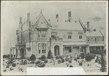 The two storeyed stucco house is symmetrically composed with a single storeyed timber verandah,
in the foreground the garden has been established, a lady and a gentleman are standing in the garden 
